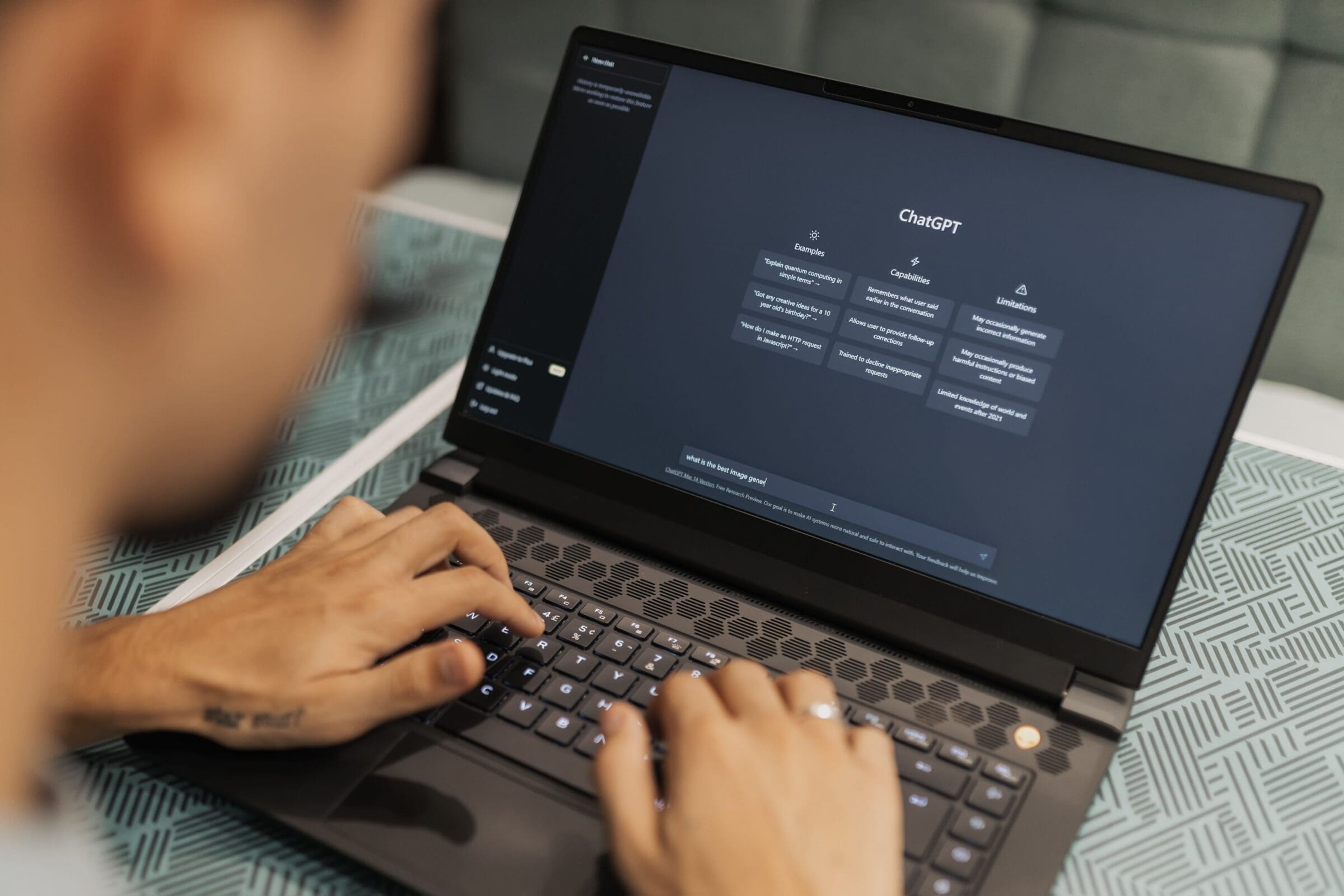 Person using ChatGPT AI search, on laptop, reflecting the theme of what is AEO and where it shows up