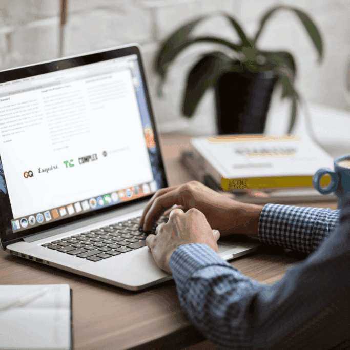 Marketing professional reviewing email newsletter performance metrics like click-through rate and conversions in the HubSpot email analytics dashboard