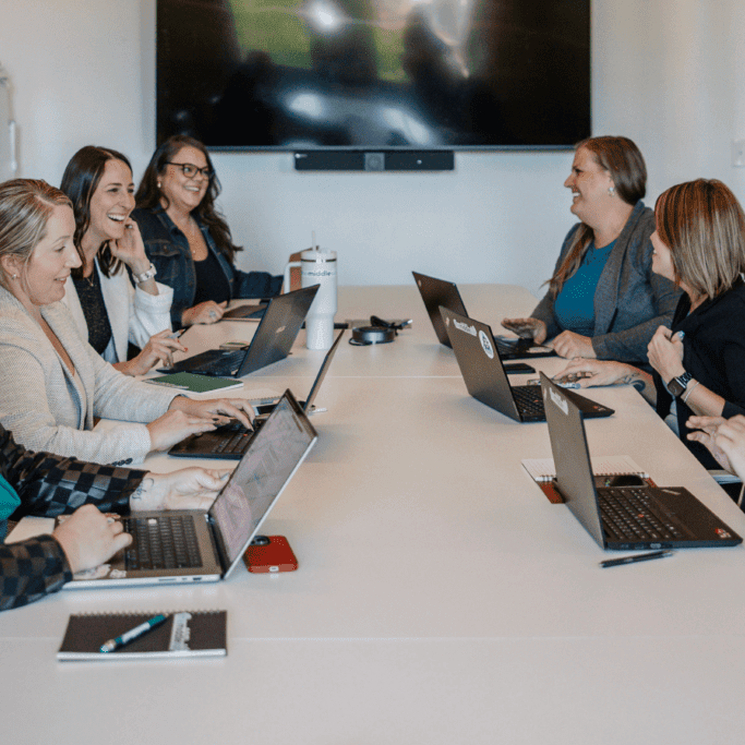 Sales team collaborating on sales enablement strategy and CRM optimization in 2025.